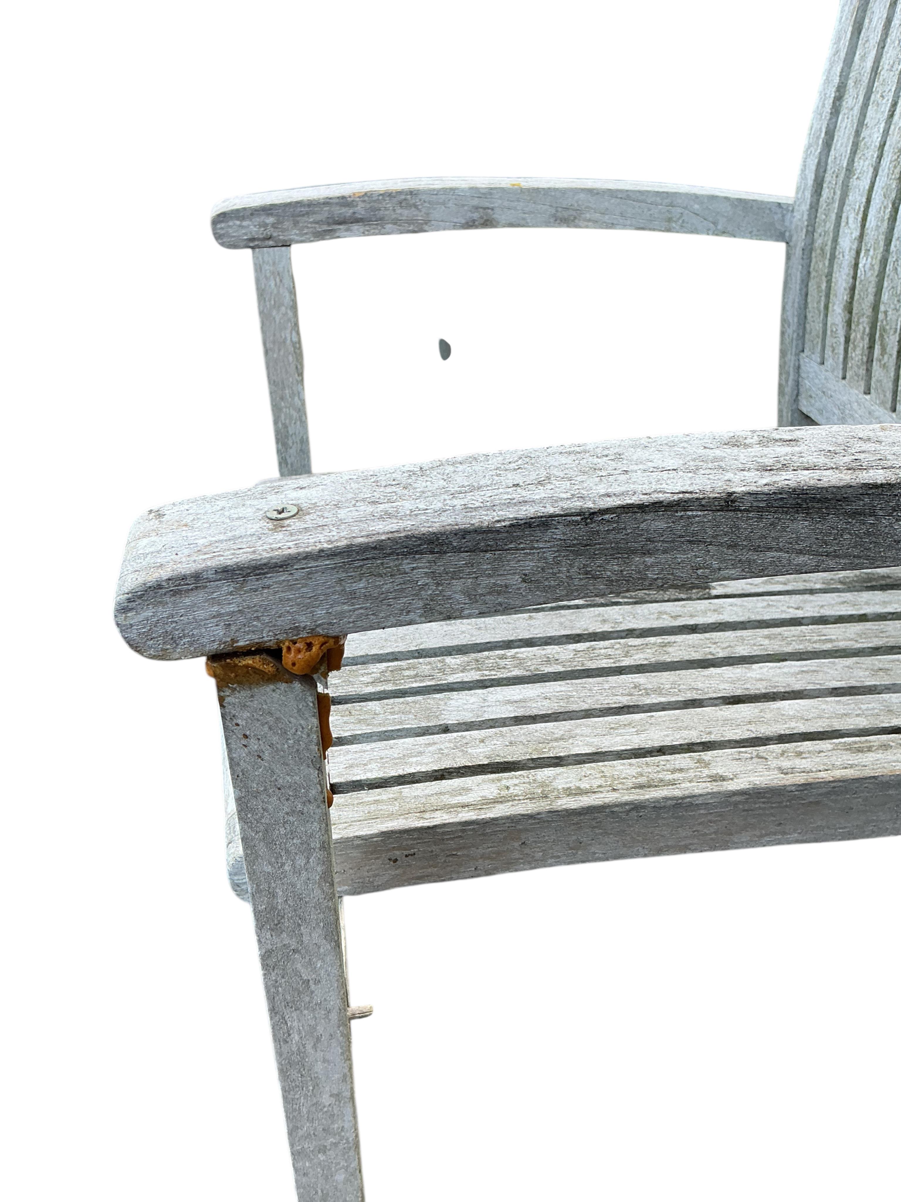 A Lindsey circular weathered teak garden table, diameter 130cm and four chairs